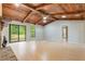 Bright, open living room with wood ceilings, fan, a brick fireplace, and sliding door access to the backyard at 8410 Lake Bosse Dr, Orlando, FL 32810