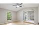 Spacious main bedroom boasts a ceiling fan, natural light, and an en-suite bathroom at 8410 Lake Bosse Dr, Orlando, FL 32810
