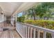Inviting front porch with wood floors and white railing with a brick accent at 8410 Lake Bosse Dr, Orlando, FL 32810
