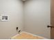 A blank utility room with painted walls and wood-look vinyl flooring at 8410 Lake Bosse Dr, Orlando, FL 32810