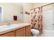 A bright bathroom features a vanity, toilet, and shower with a curtain at 866 Ashworth Overlook Dr # B, Apopka, FL 32712