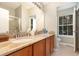 Bathroom with double sink vanity, granite countertop, and a large mirror above at 866 Ashworth Overlook Dr # B, Apopka, FL 32712