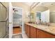 Bathroom featuring double sink vanity with granite countertops, wooden cabinets, and a walk-in shower at 866 Ashworth Overlook Dr # B, Apopka, FL 32712