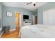 Primary bedroom boasts wood floors, a ceiling fan, a mounted television, and access to ensuite bathroom at 866 Ashworth Overlook Dr # B, Apopka, FL 32712