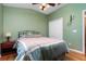 A cozy bedroom features hardwood floors, a metal frame bed, and a comfortable comforter at 866 Ashworth Overlook Dr # B, Apopka, FL 32712
