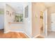Bright entryway featuring wood floors, a half wall pass-through, and access to a half bathroom at 866 Ashworth Overlook Dr # B, Apopka, FL 32712