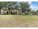A view of townhome exteriors with landscaping and beautiful trees at 866 Ashworth Overlook Dr # B, Apopka, FL 32712