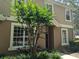 Exterior front view of a two-story townhome with a tree at 866 Ashworth Overlook Dr # B, Apopka, FL 32712