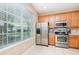 Bright kitchen features stainless steel appliances, tile floors, and a large window with natural light at 866 Ashworth Overlook Dr # B, Apopka, FL 32712