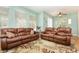 Inviting living room featuring hardwood floors and comfortable leather couches at 866 Ashworth Overlook Dr # B, Apopka, FL 32712