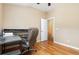 A home office is bright with hardwood floors, a neutral color scheme, and desk at 866 Ashworth Overlook Dr # B, Apopka, FL 32712