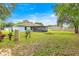 Large backyard with well and screened-in patio providing ample outdoor space for relaxing and recreation at 8869 Se 159Th Pl, Summerfield, FL 34491