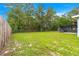 Large backyard with a shed and screened-in patio providing extra storage and relaxation space at 8869 Se 159Th Pl, Summerfield, FL 34491