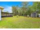 Spacious backyard features a shed and screened-in patio, providing storage and a relaxing outdoor space at 8869 Se 159Th Pl, Summerfield, FL 34491