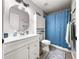 Cozy bathroom with a single vanity, tile flooring, and a blue shower curtain at 8869 Se 159Th Pl, Summerfield, FL 34491