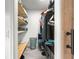 Walk-in closet with built-in storage, wooden shelves, and plenty of room for organization at 8869 Se 159Th Pl, Summerfield, FL 34491
