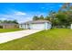 Well-kept home featuring a two-car garage and a spacious driveway, offering a blend of comfort and style at 8869 Se 159Th Pl, Summerfield, FL 34491