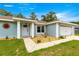 Inviting entrance with decorative details, pathway, and a well-manicured lawn at 8869 Se 159Th Pl, Summerfield, FL 34491