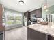 Modern kitchen with stainless steel appliances, marble counters, and a functional island with barstool seating at 8869 Se 159Th Pl, Summerfield, FL 34491