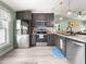 A kitchen with gray cabinets, stainless steel appliances, and granite countertops at 8869 Se 159Th Pl, Summerfield, FL 34491