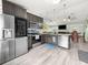 A kitchen with gray cabinets, stainless steel appliances, and an open floor plan at 8869 Se 159Th Pl, Summerfield, FL 34491