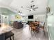Living room with an open floor plan to the dining room and kitchen at 8869 Se 159Th Pl, Summerfield, FL 34491