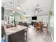 Open floor plan with a kitchen island, dining table, and living room at 8869 Se 159Th Pl, Summerfield, FL 34491