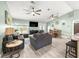 Living room with gray sofas, a TV, and a view of the backyard at 8869 Se 159Th Pl, Summerfield, FL 34491