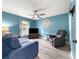 Comfortable living room featuring hardwood floors, a ceiling fan, and comfortable seating at 8869 Se 159Th Pl, Summerfield, FL 34491