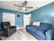 Bright living room with wood floors, fan, modern furniture, and closet for a comforting and practical area at 8869 Se 159Th Pl, Summerfield, FL 34491