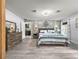 Stylishly decorated main bedroom featuring a blue floral accent wall and gray wood-look flooring at 8869 Se 159Th Pl, Summerfield, FL 34491