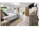 A bedroom with a king bed, barn doors, and a TV at 8869 Se 159Th Pl, Summerfield, FL 34491
