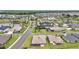 Community aerial view showcases many homes, green spaces, and lakes, connected by winding roads at 892 Hubbard Loop, The Villages, FL 32163