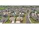 An aerial view displays this expansive community featuring a golf course, lake, and well-maintained homes at 892 Hubbard Loop, The Villages, FL 32163