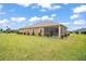 Exterior view showing backyard, screened lanai, and patio at 892 Hubbard Loop, The Villages, FL 32163