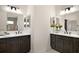 Dual sink bathroom with dark wood cabinets, white countertops, and large mirrors at 892 Hubbard Loop, The Villages, FL 32163