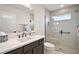 Bright bathroom features glass enclosed shower, modern vanity, and neutral tile at 892 Hubbard Loop, The Villages, FL 32163