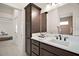 Elegant bathroom featuring dark wood cabinets, a white countertop, and ample lighting at 892 Hubbard Loop, The Villages, FL 32163