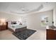 Bright bedroom featuring a tray ceiling, ceiling fan, and tile floors at 892 Hubbard Loop, The Villages, FL 32163