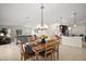 Open-concept dining area with tile floors, pendant lighting, and a seamless flow into the living room at 892 Hubbard Loop, The Villages, FL 32163