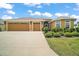 Charming single-story home with a three-car garage, beautiful landscaping, and a well-maintained lawn at 892 Hubbard Loop, The Villages, FL 32163