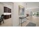 Spacious foyer with tile flooring, artwork, and views of the kitchen and dining area beyond at 892 Hubbard Loop, The Villages, FL 32163
