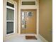 Inviting front door with decorative glass and a 'Welcome Home' mat, framed by sidelight windows at 892 Hubbard Loop, The Villages, FL 32163
