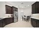Open kitchen featuring stainless steel appliances, dark wood cabinets, and a bright breakfast nook at 892 Hubbard Loop, The Villages, FL 32163