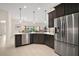 Gourmet kitchen with stainless steel appliances, dark wood cabinets, and a spacious layout at 892 Hubbard Loop, The Villages, FL 32163