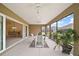 Spacious screened lanai with ceiling fans and view of the dining room at 892 Hubbard Loop, The Villages, FL 32163