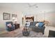 Open-concept living room featuring tile flooring, comfortable seating, and a view into the dining area at 892 Hubbard Loop, The Villages, FL 32163
