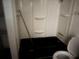A full bathroom featuring a black tub, toilet, and white wall with shelving at 916 Kentucky St, Haines City, FL 33844