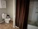 A full bathroom featuring a toilet, bathtub, and shelving at 916 Kentucky St, Haines City, FL 33844