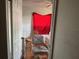 Bedroom view with desk chair, wooden chairs, and window with a red curtain at 916 Kentucky St, Haines City, FL 33844